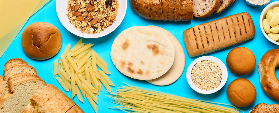 Assorted gluten free bread and pasta items on a blue background